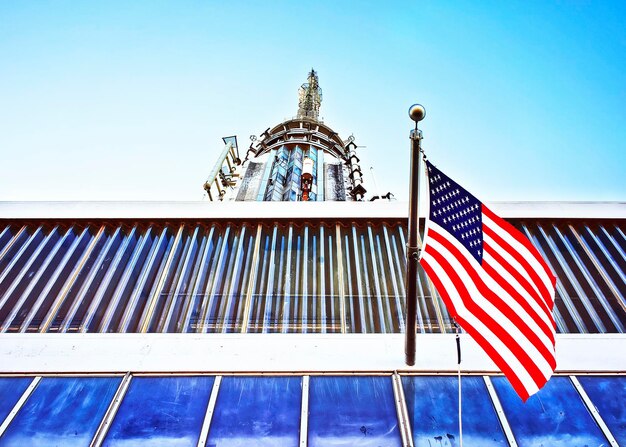 A close-up shot of the Federal Reserve building in Washington D.C., with the American flag waving in the background, symbolizing the institution's role in shaping the U.S. economy.