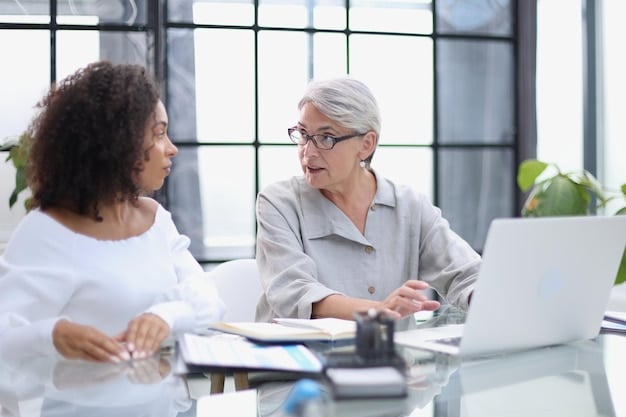 An older woman talking with a Social Security Administration (SSA) representative at a desk, both looking at documents.